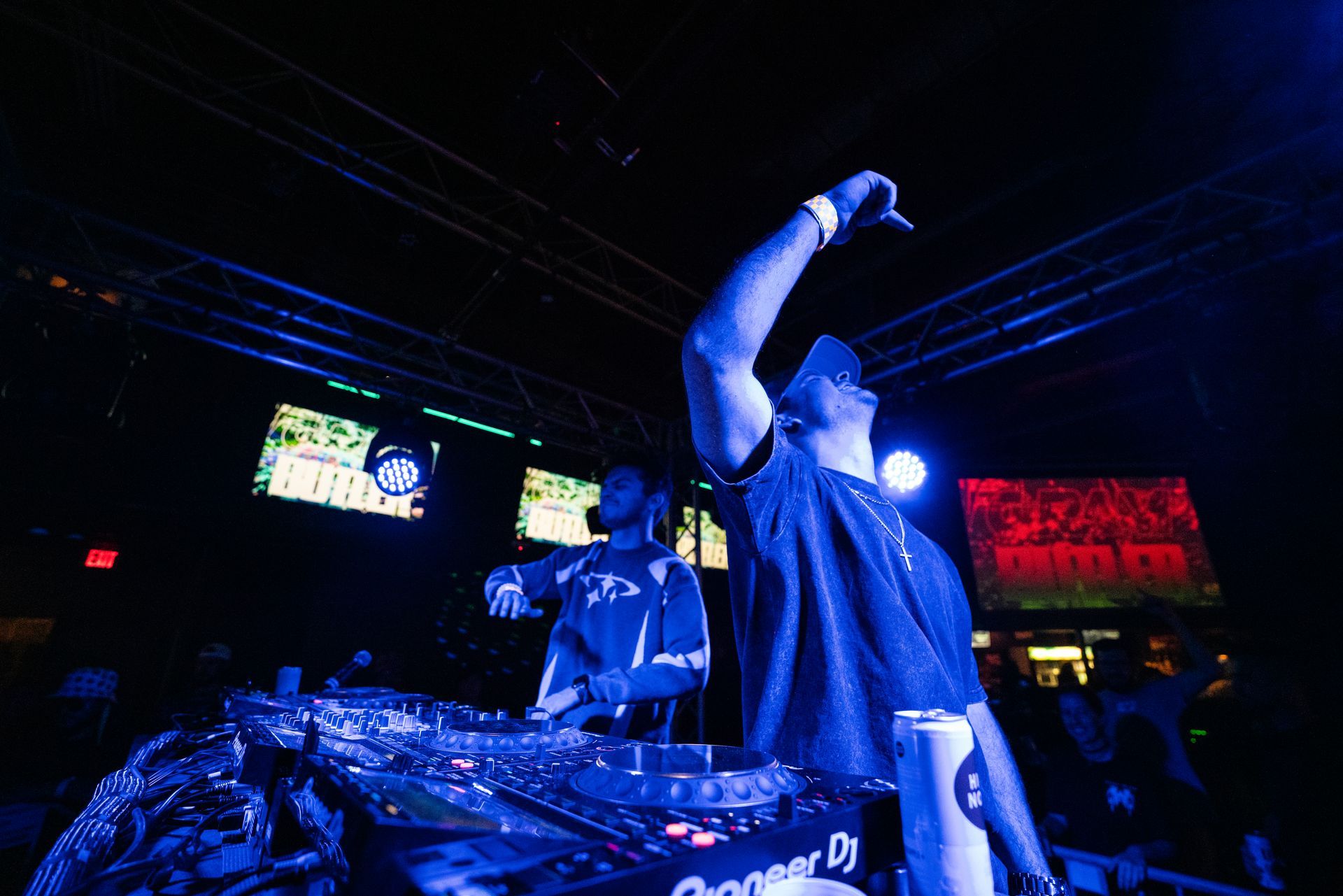 A man is singing into a microphone on a stage in front of a crowd.