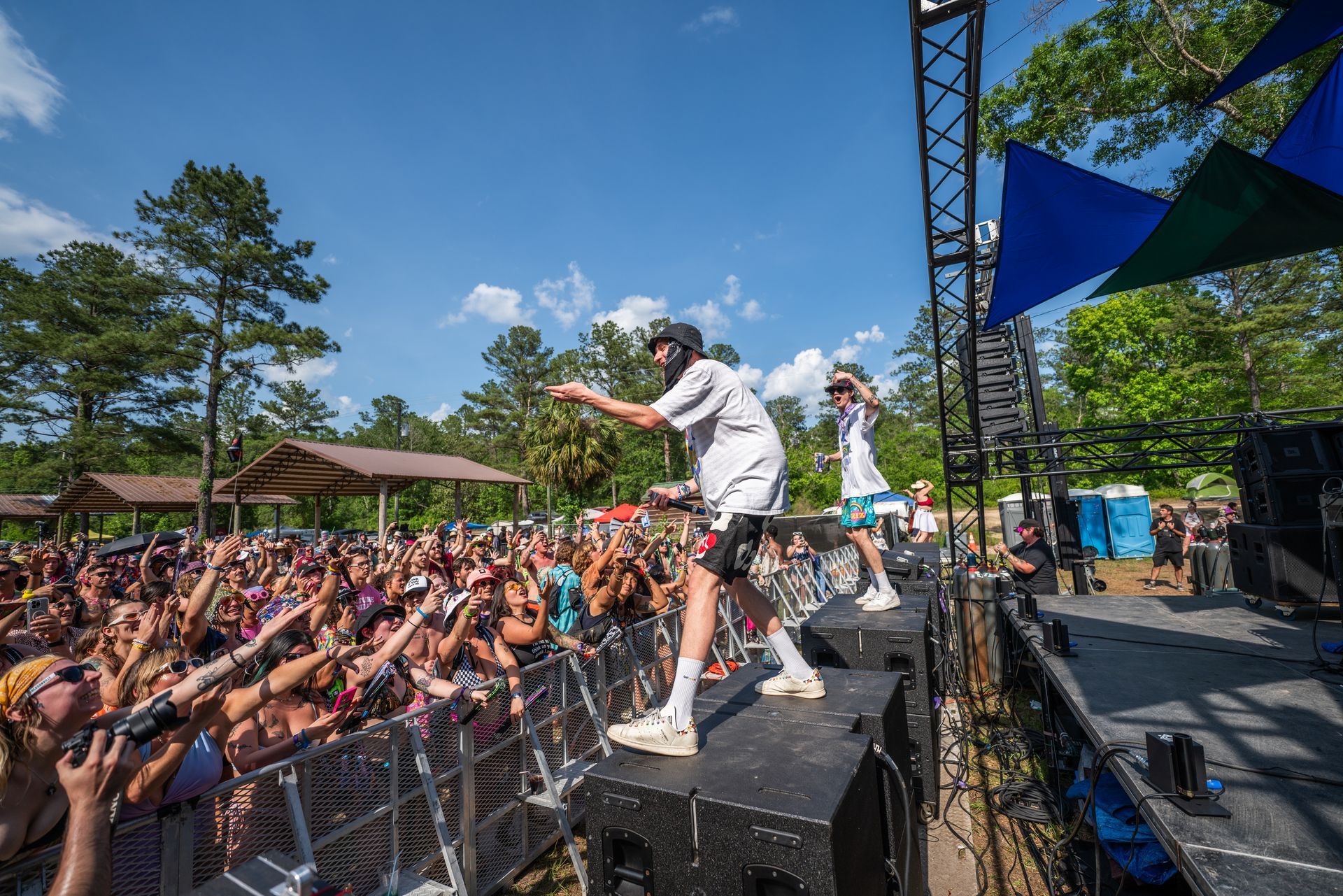 A man is standing on top of a stage in front of a crowd.