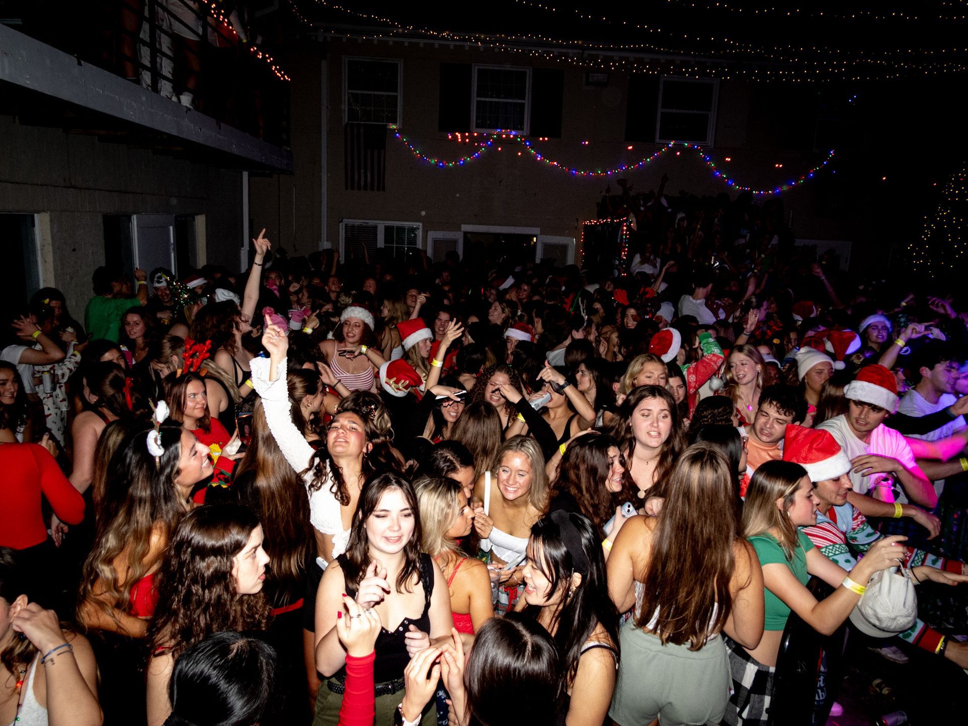 A large group of people are dancing at a christmas party