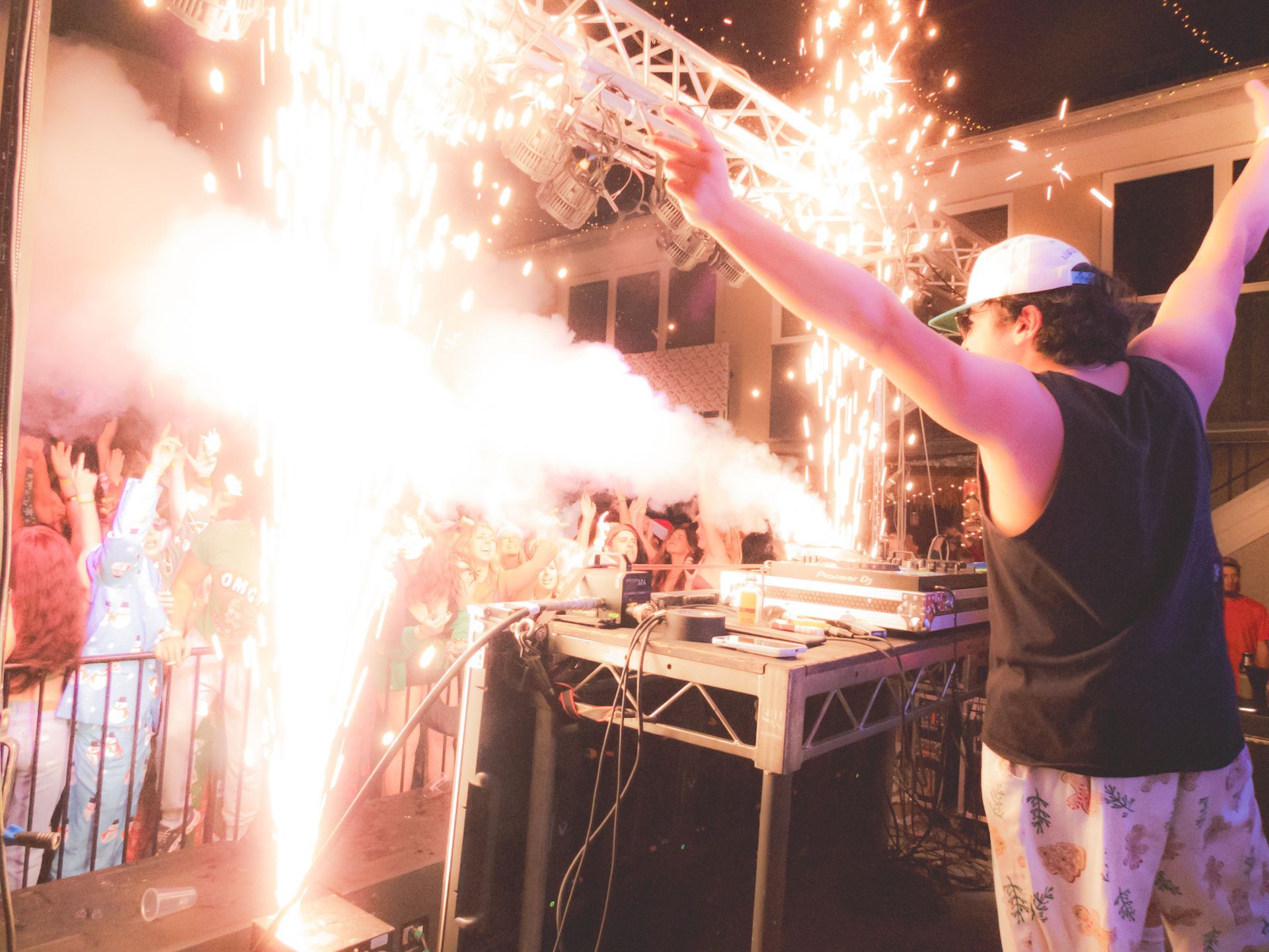 A man is standing in front of a fireworks display