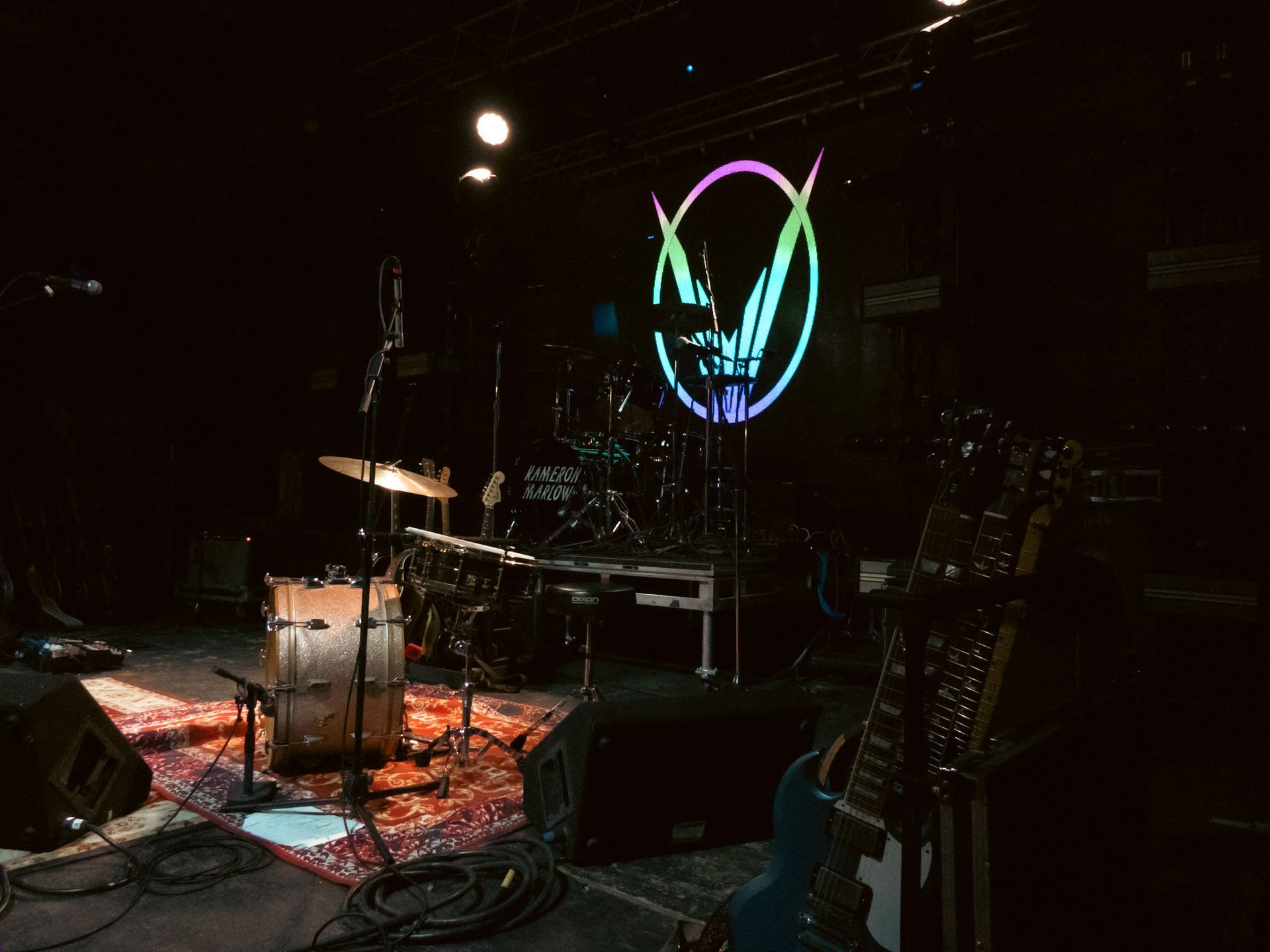 A stage with a drum set and a guitar on it
