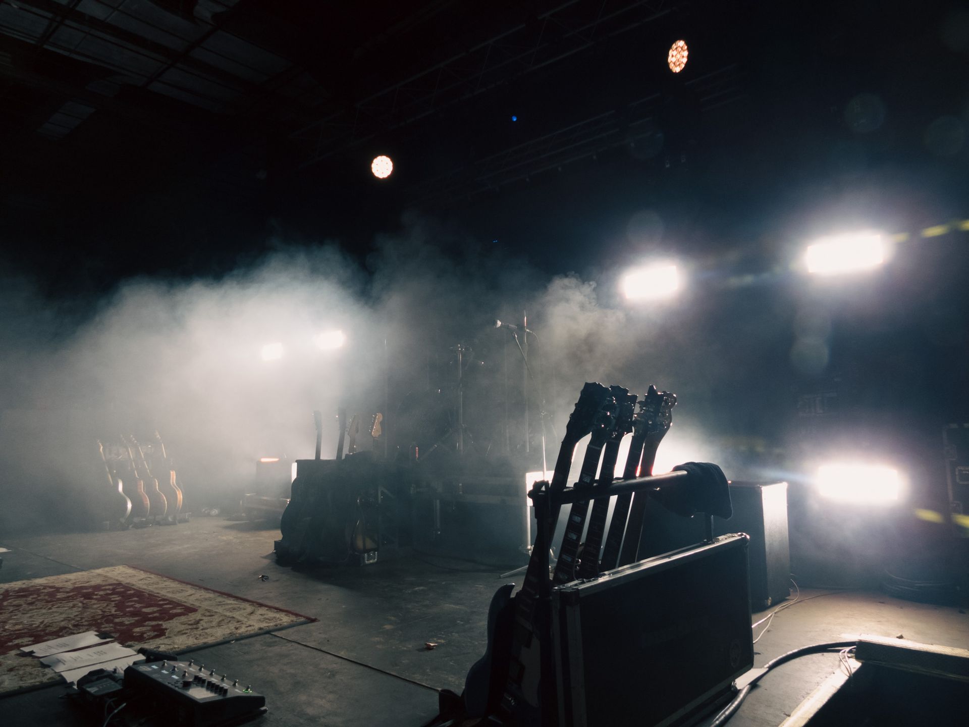 A stage with a lot of lights and smoke coming out of it.