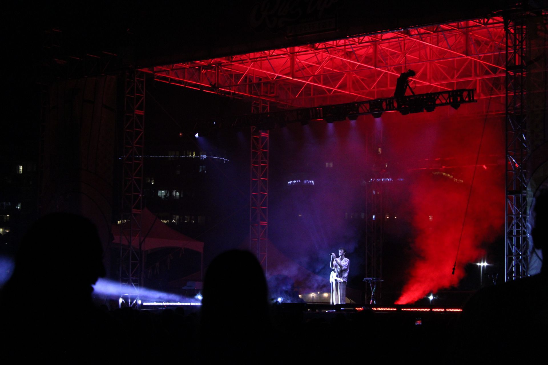 A stage with red lights and smoke coming out of it