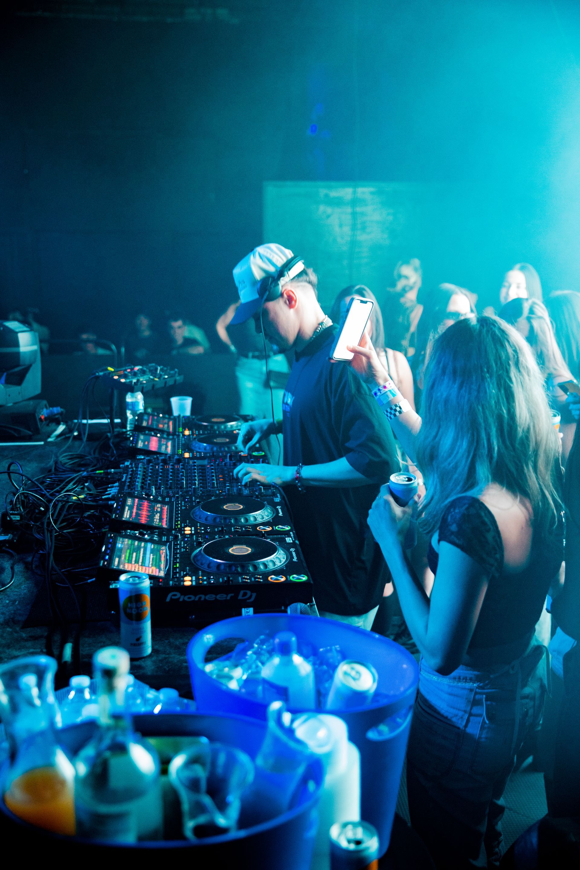 A man and a woman are playing music in a club