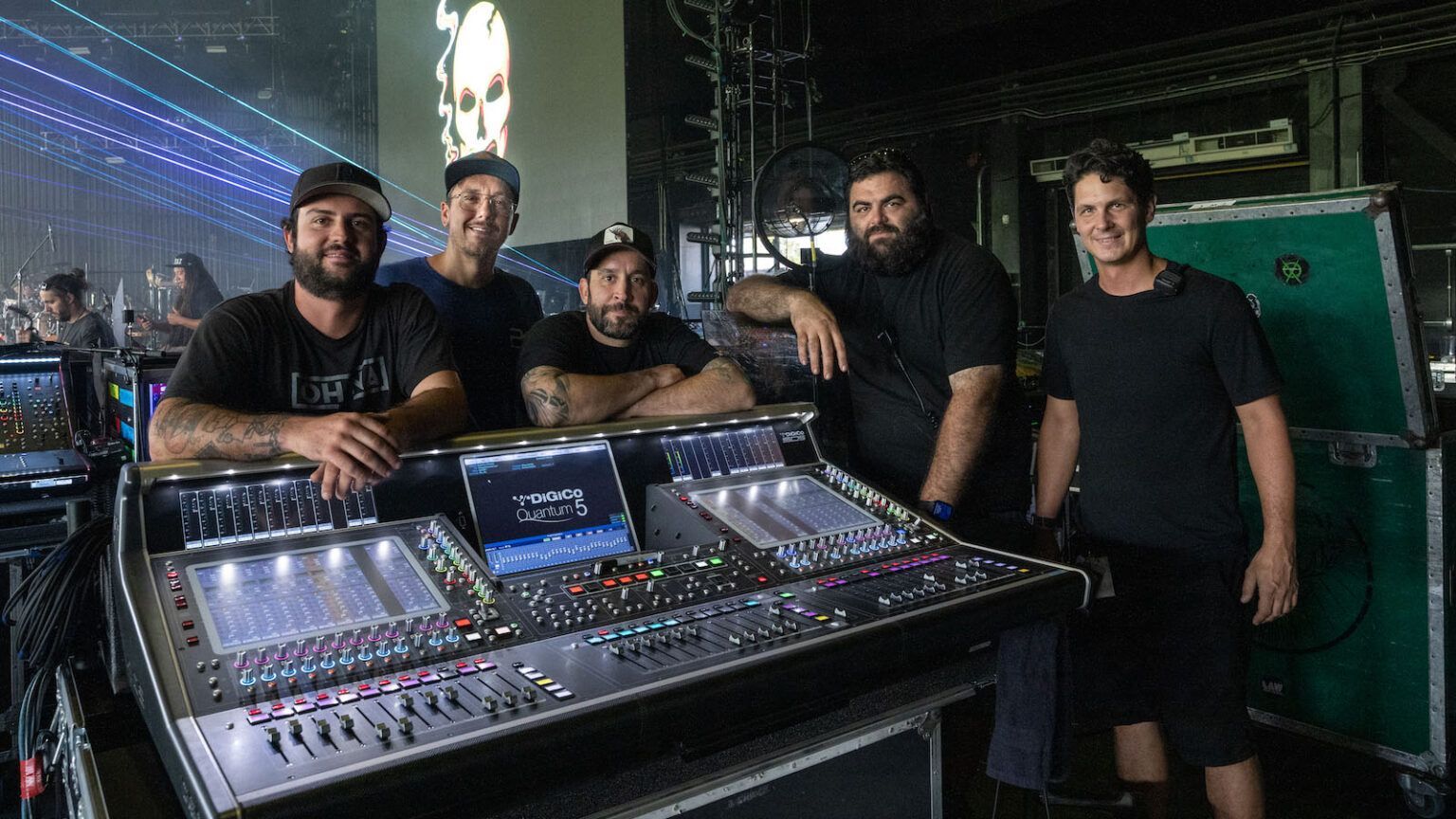 A group of men are posing for a picture in front of a mixer.