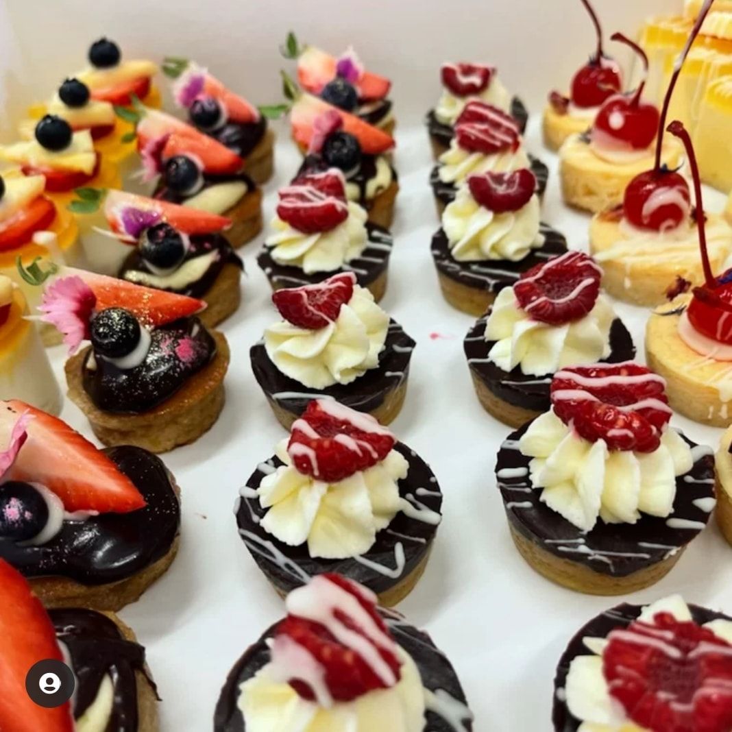 There Are Two Plates of Food on the Table, One of Which is a Salad — My Rainbow Bakery, Cafe & Catering in Cannonvale, QLD