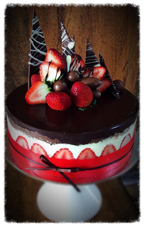 A chocolate cake with strawberries and chocolate on top — My Rainbow Bakery, Cafe & Catering in Cannonvale, QLD