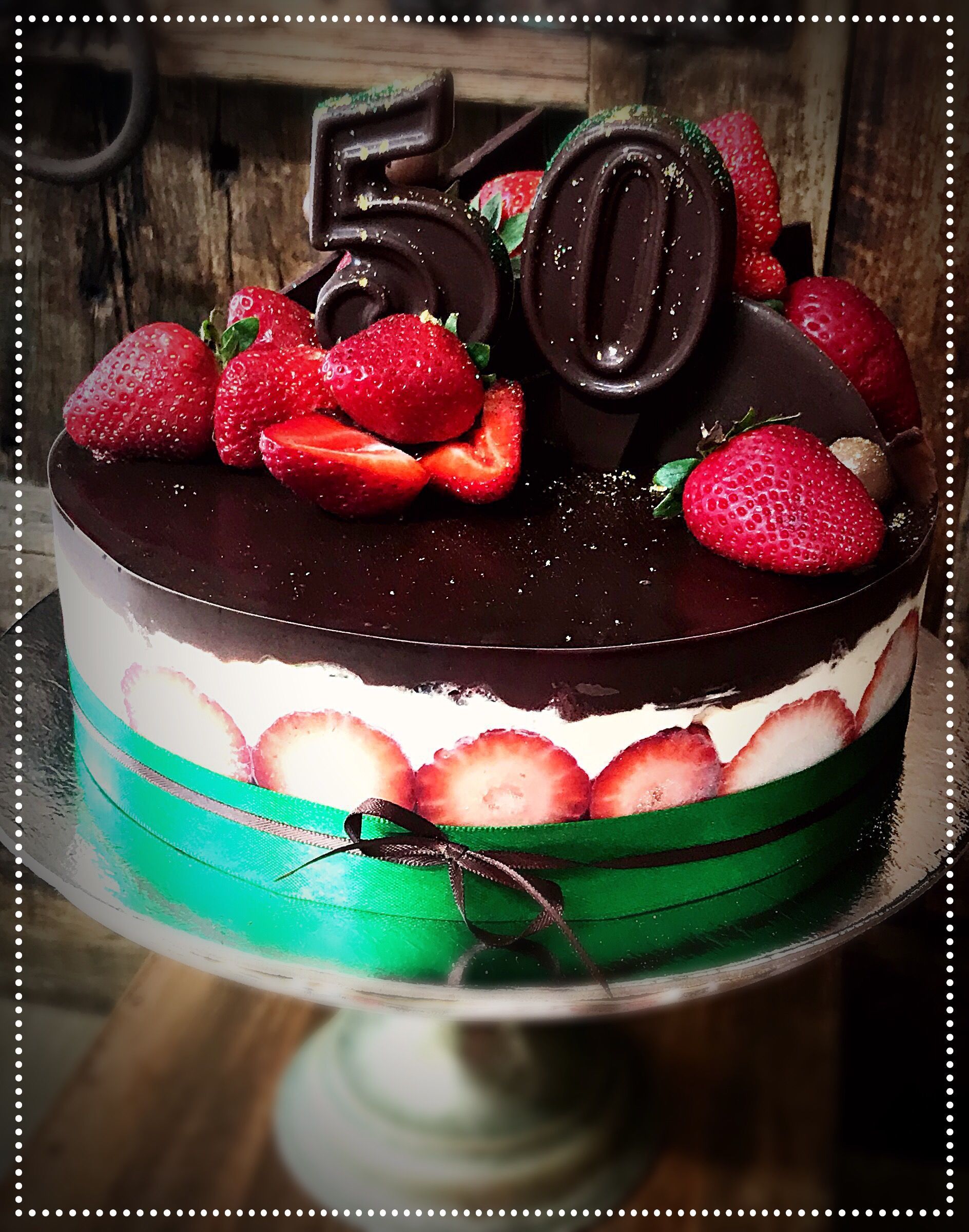 A chocolate cake with strawberries and the number 50 on top — My Rainbow Bakery, Cafe & Catering in Cannonvale, QLD