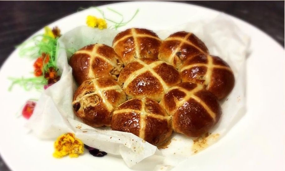A Bunch of Bread With Smiley Faces on Them on a Tray — My Rainbow Bakery, Cafe & Catering in Cannonvale, QLD