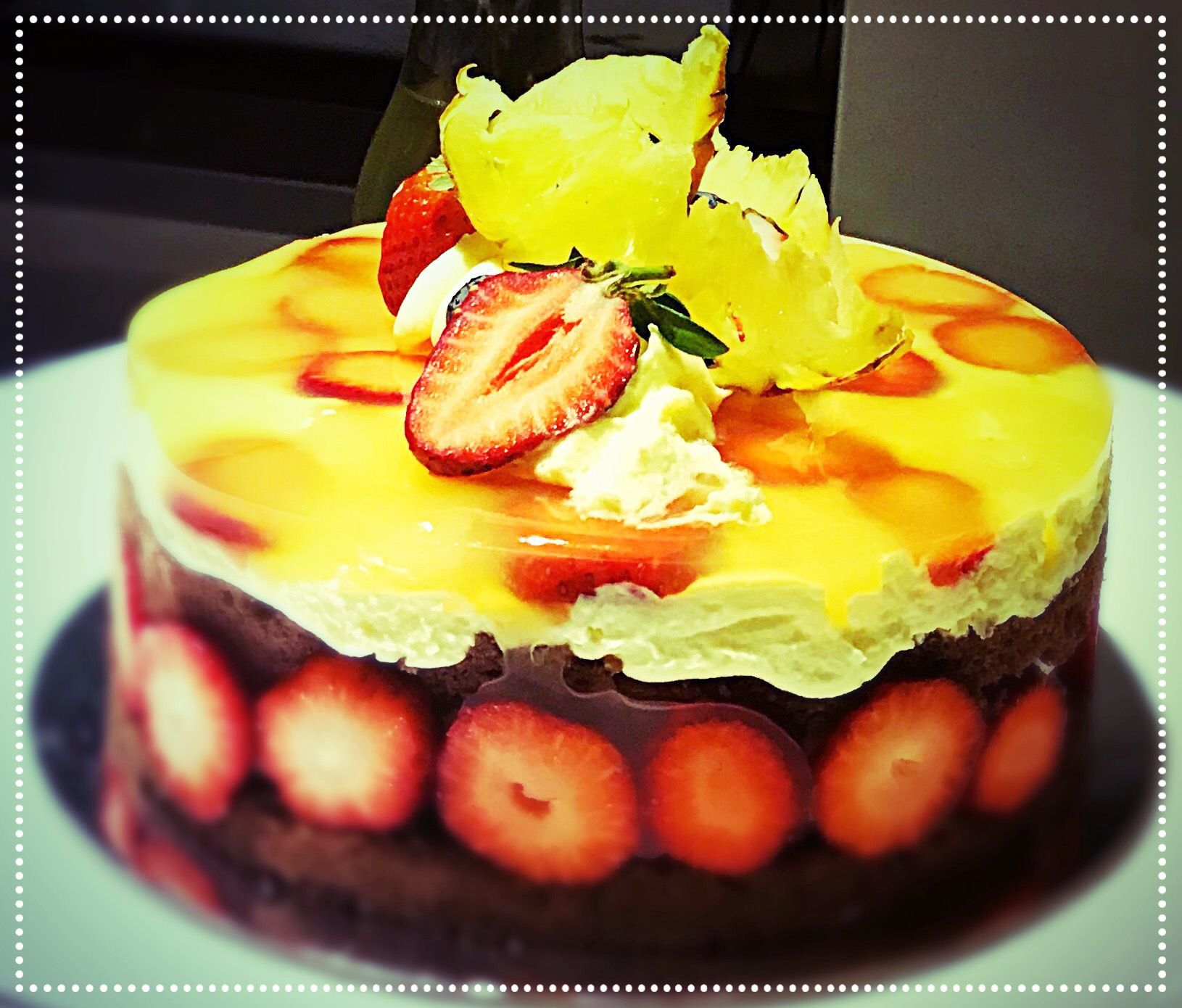 A yellow cake with strawberries on top of it — My Rainbow Bakery, Cafe & Catering in Cannonvale, QLD