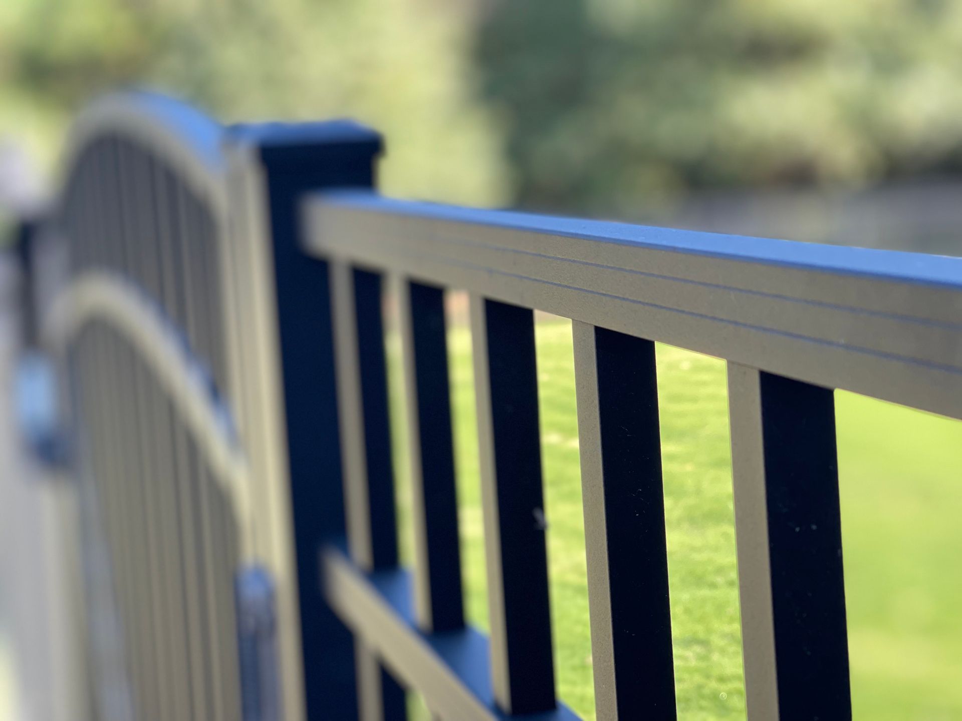 A close up of a blue railing with a blurred background