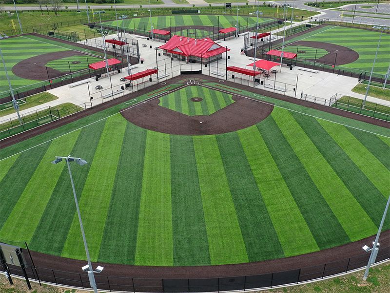 An aerial view of a baseball field with a red roof.