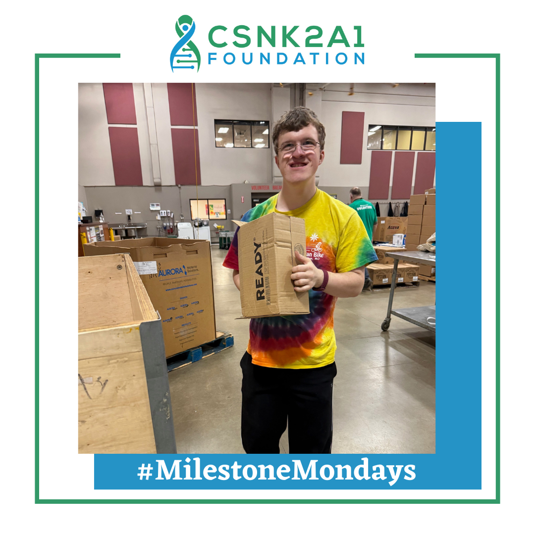 Person holding a cardboard box with