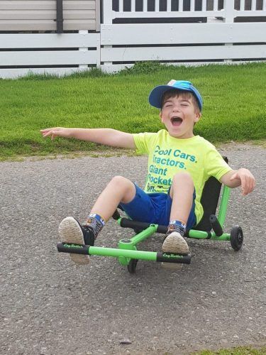 Oliver riding a little scooter