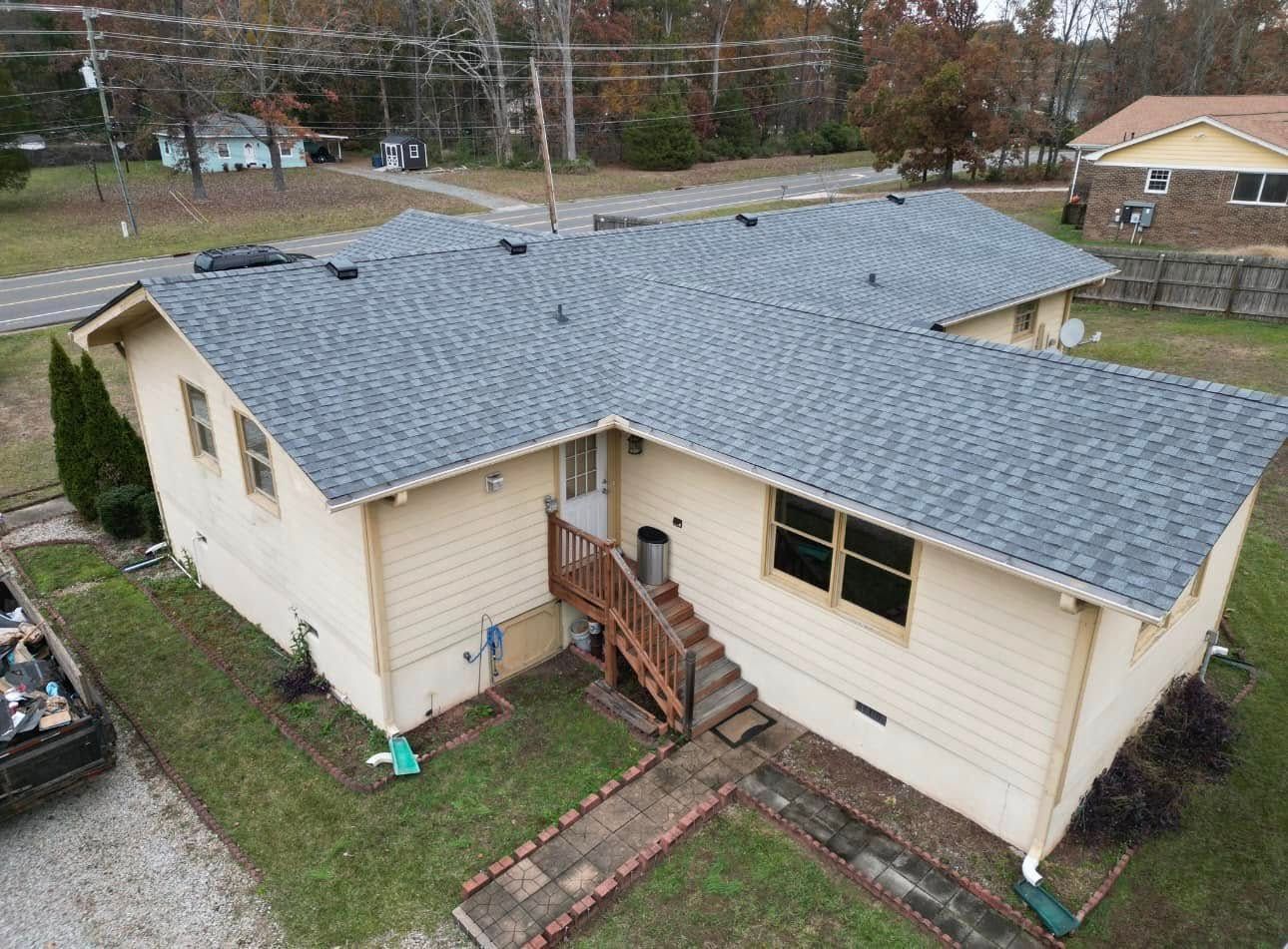 An aerial view of a house with a new roof.