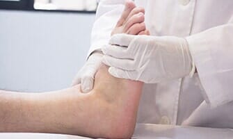 Surgeon Doctor Examining Patient — Foot Doctors in Kansas City, MO