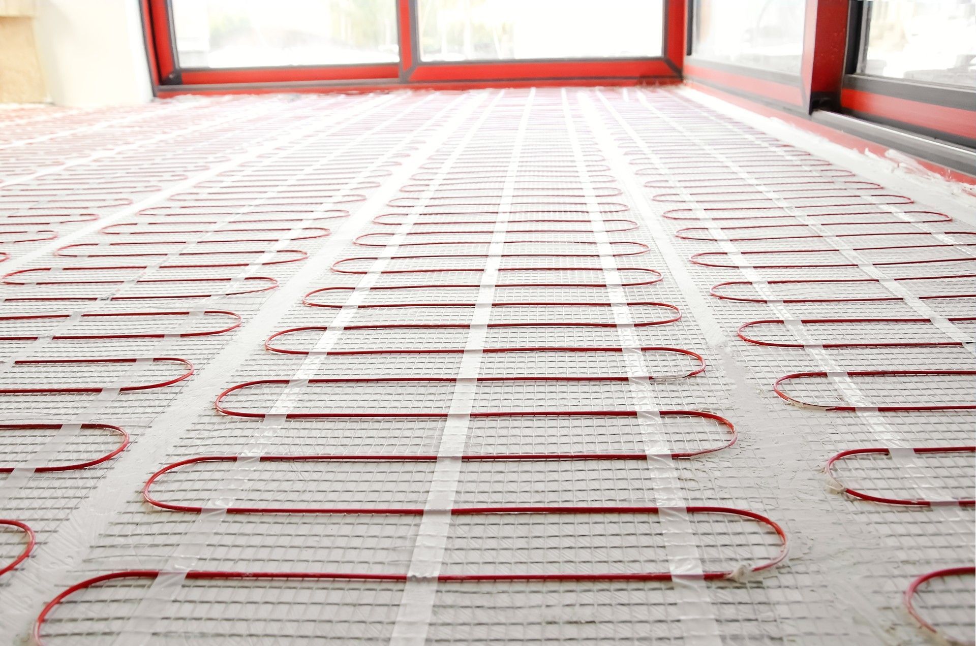 A close up of a heated floor in a room with a sliding glass door.