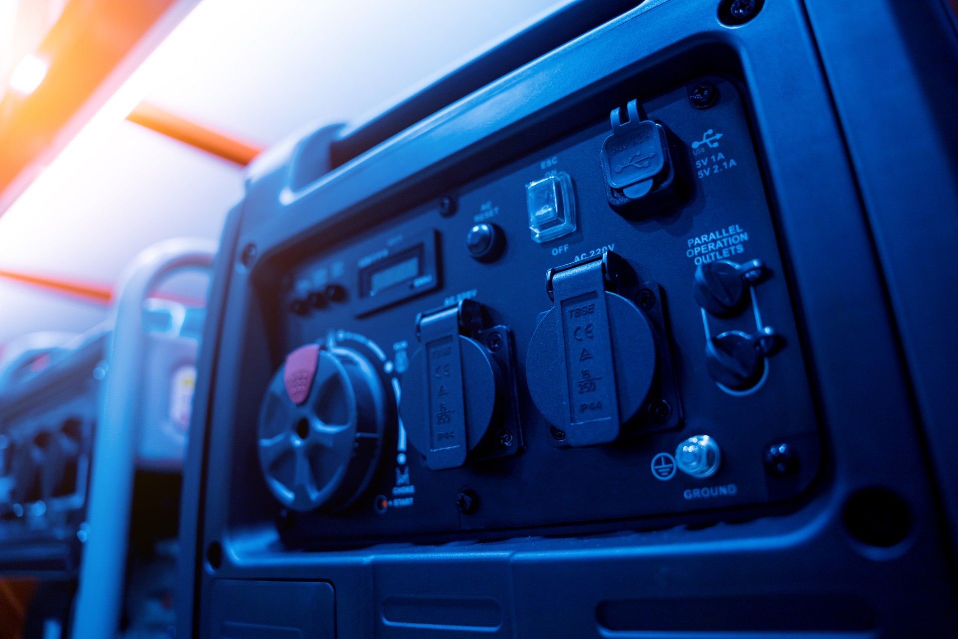 A close up of a portable generator with a blue light behind it.