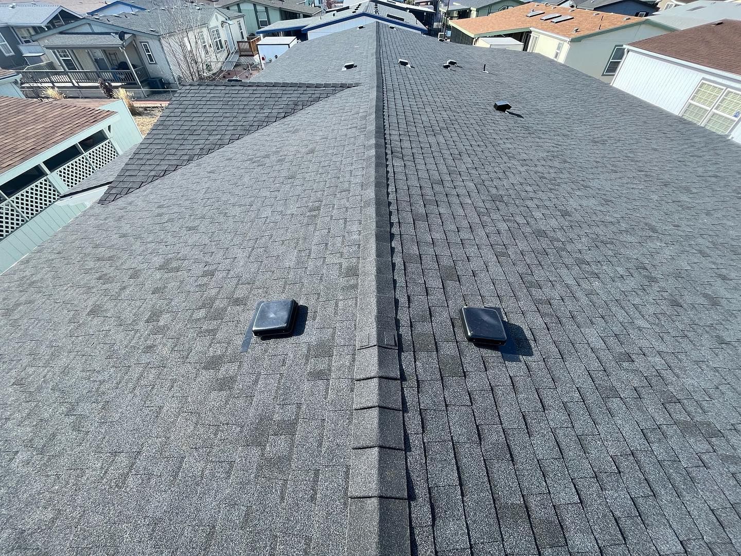 A roof with a lot of shingles and a chimney on it.