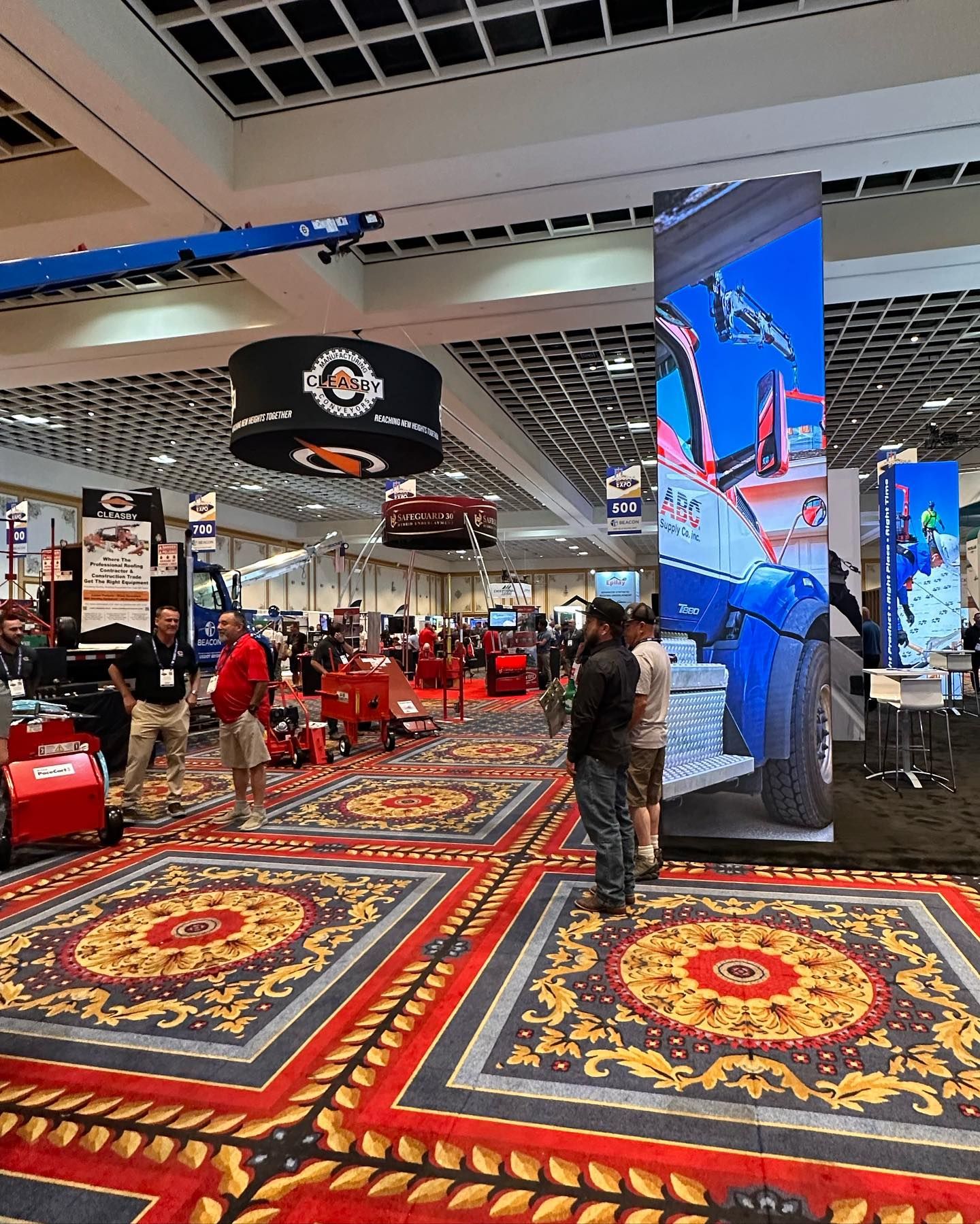 A group of people are standing in a large room.