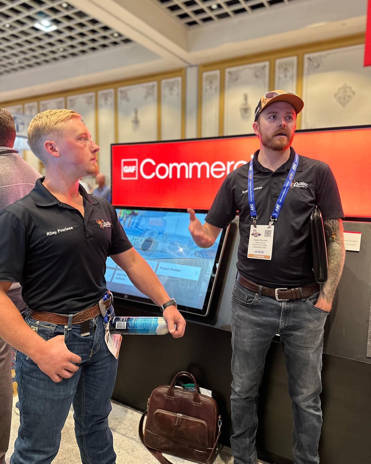 Two men are standing in front of a sign that says commer