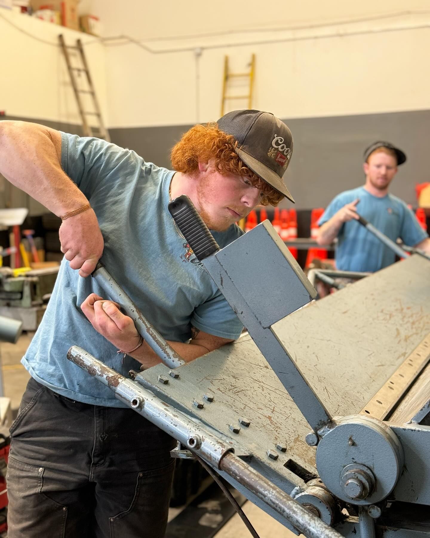 A man is working on a machine in a factory.