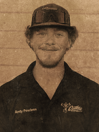 A man wearing a hat and a shirt with the name andy powless on it