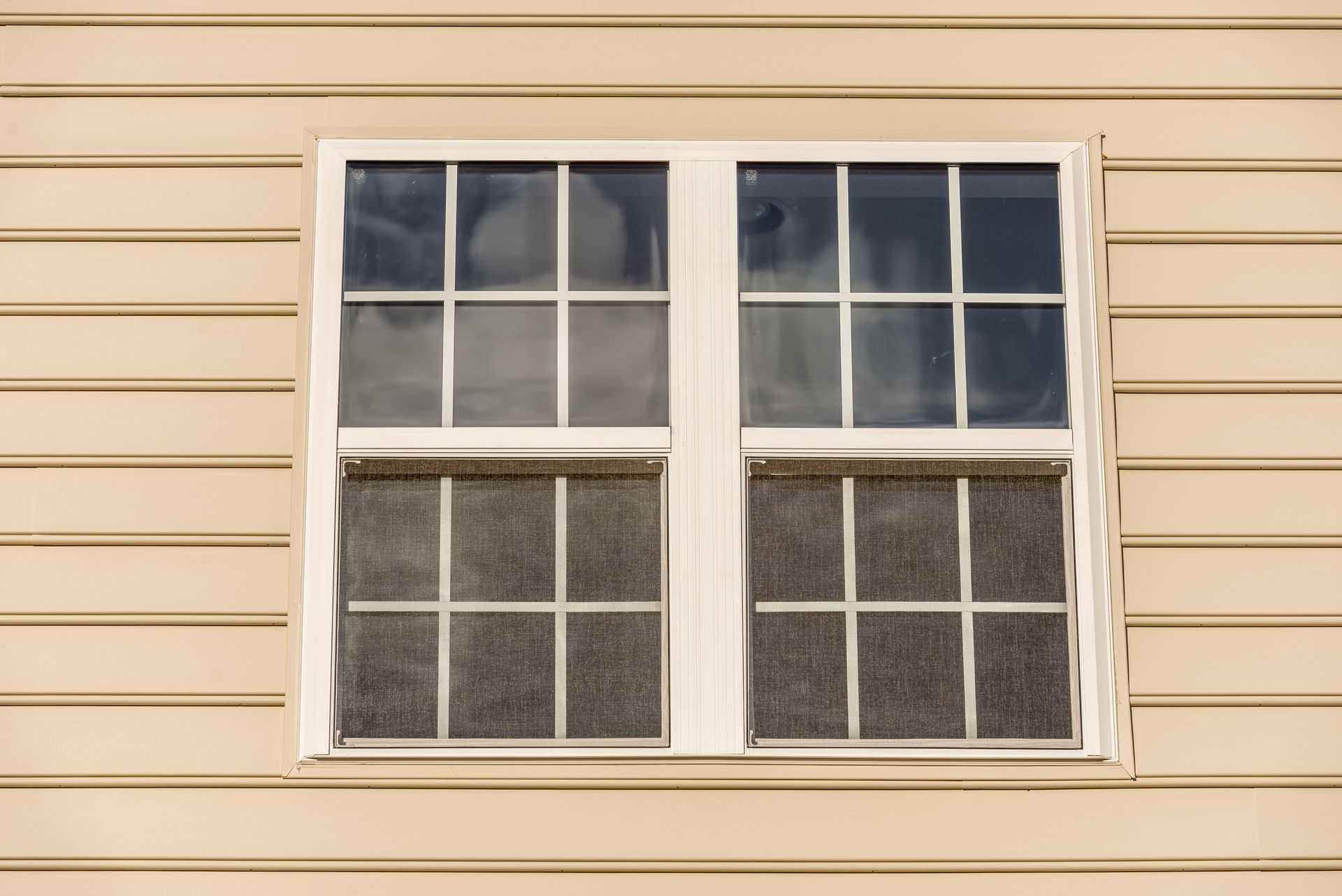 A close up of a window on the side of a house.