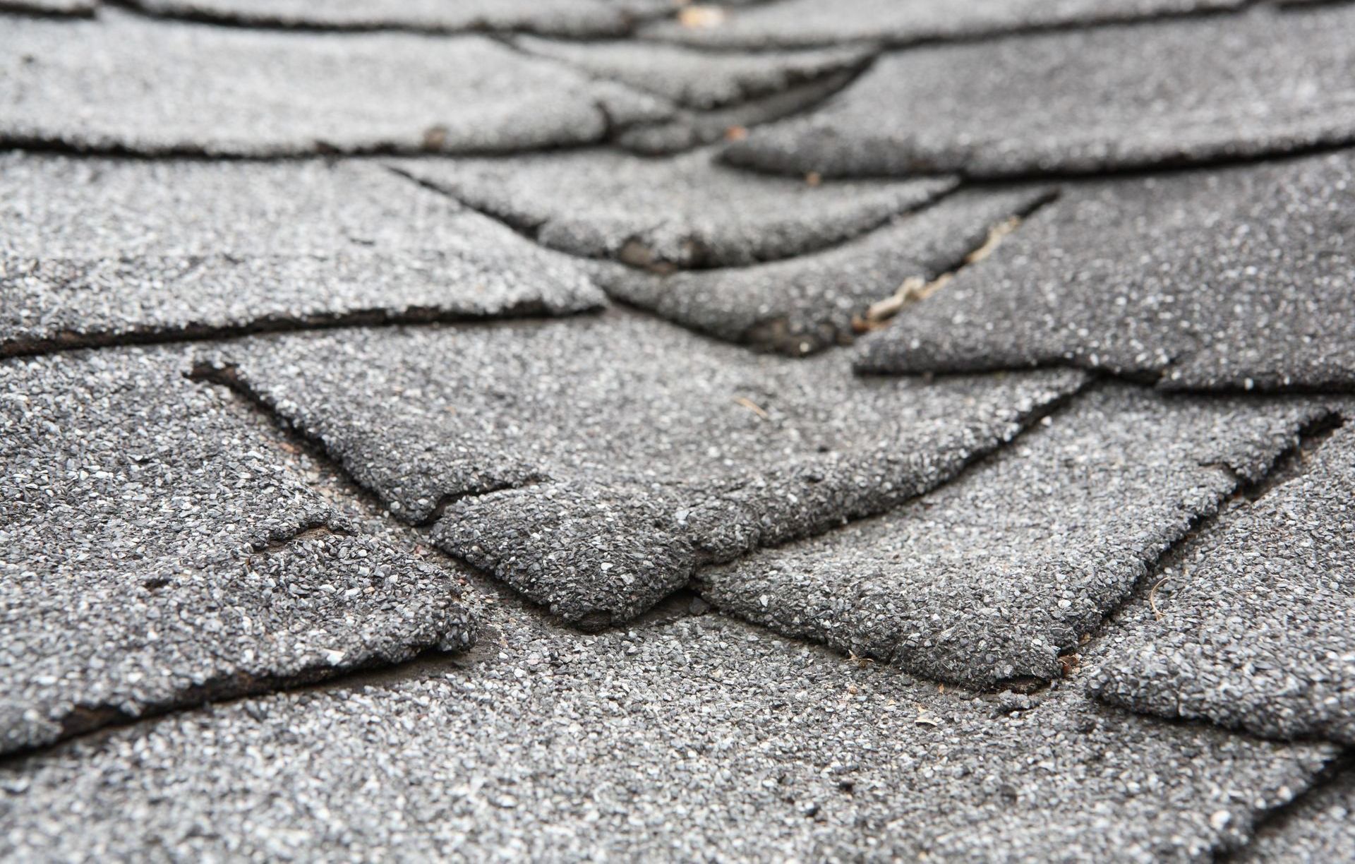 A close up of a roof with a lot of shingles on it.