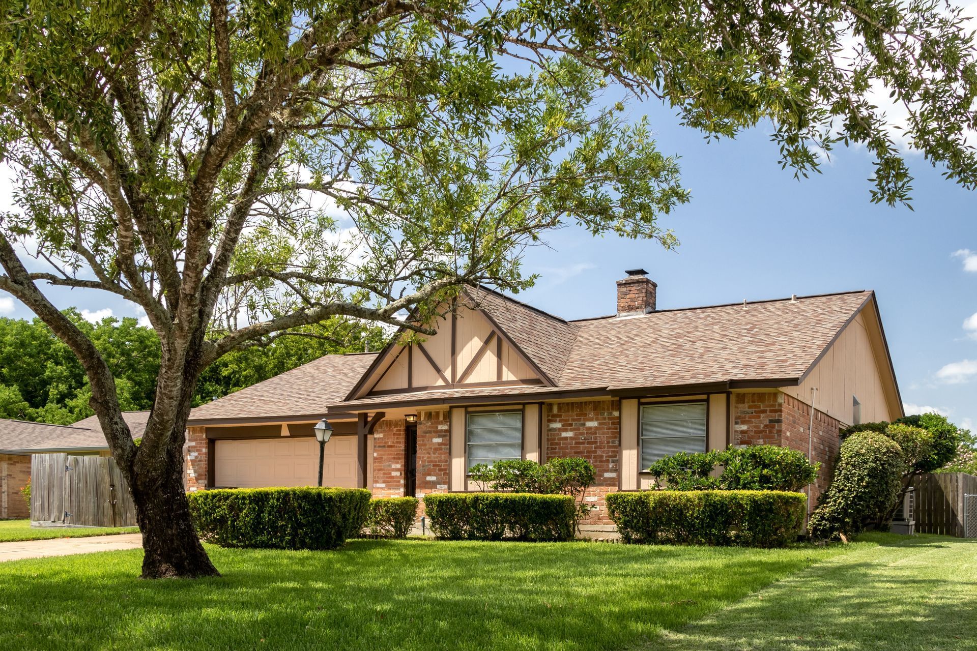 A brick house with a tree in front of it