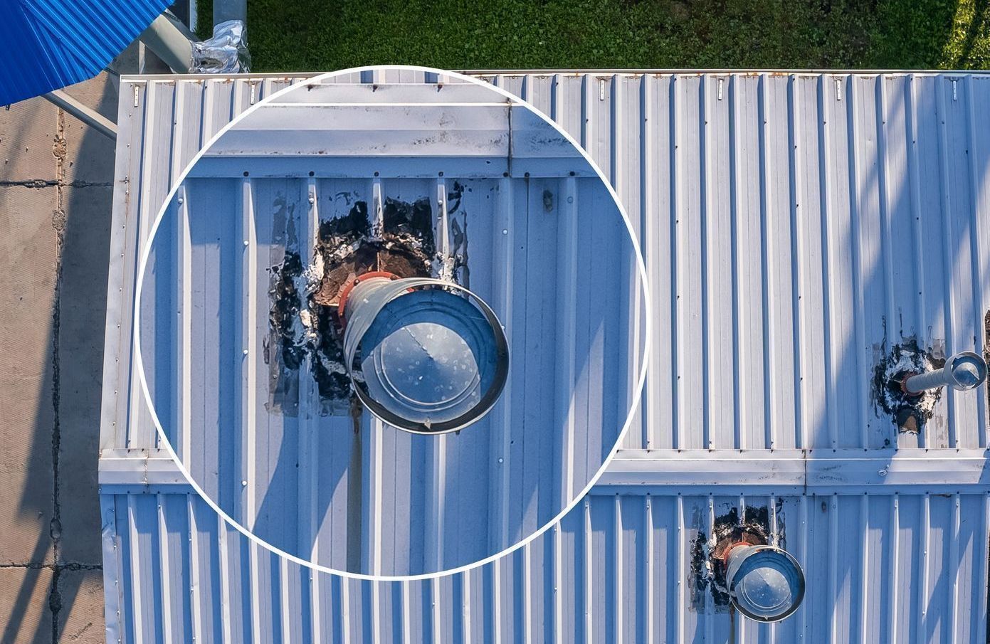 An aerial view of a roof of a building with a pipe coming out of it.