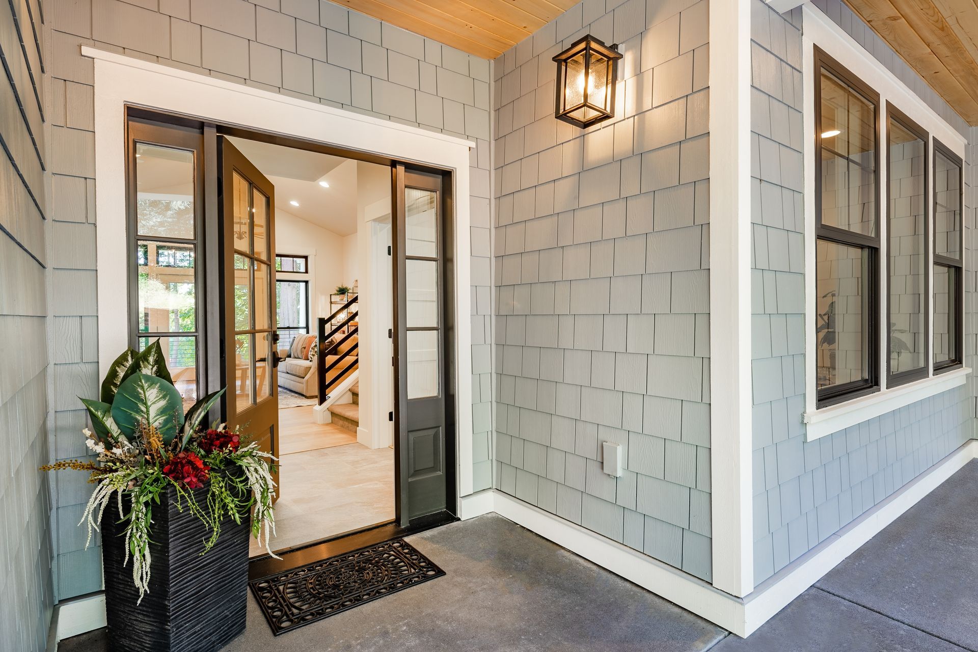 The front door of a house with a potted plant in front of it.