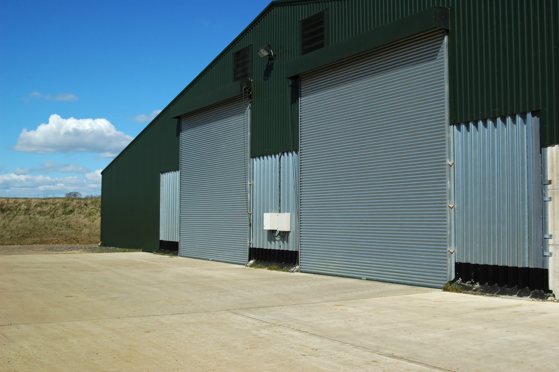 A green building with a lot of sliding doors