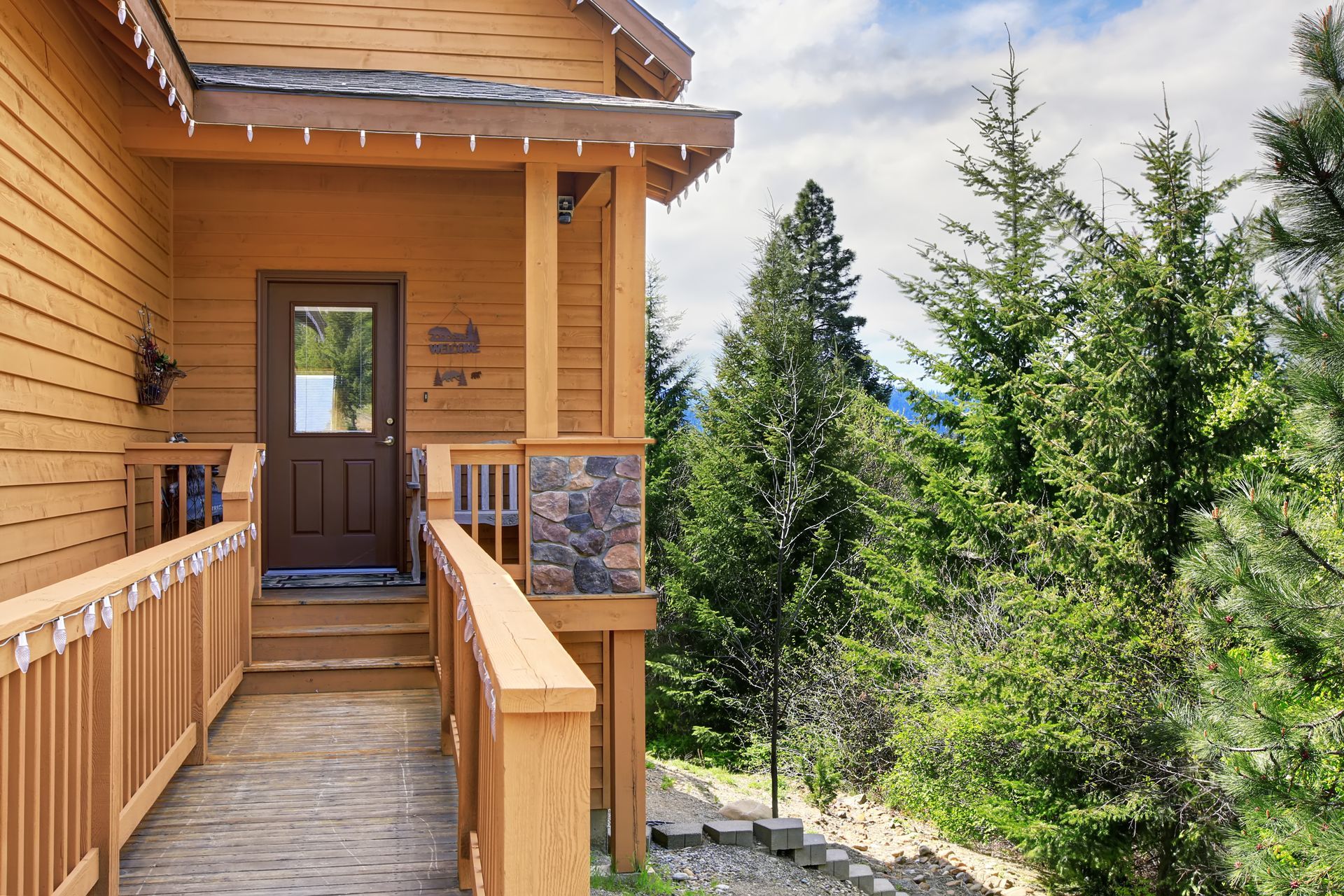 A wooden house with a ramp leading to the front door