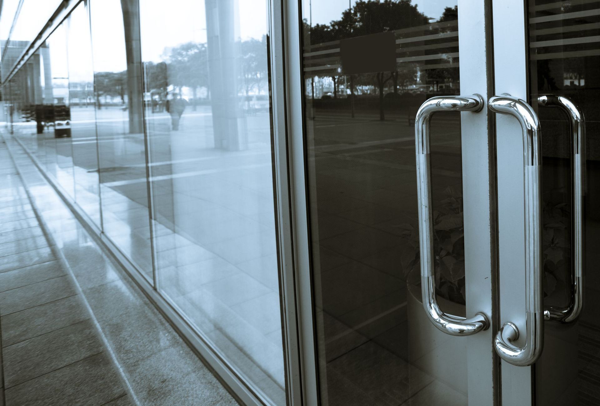 A reflection of a building in a glass door