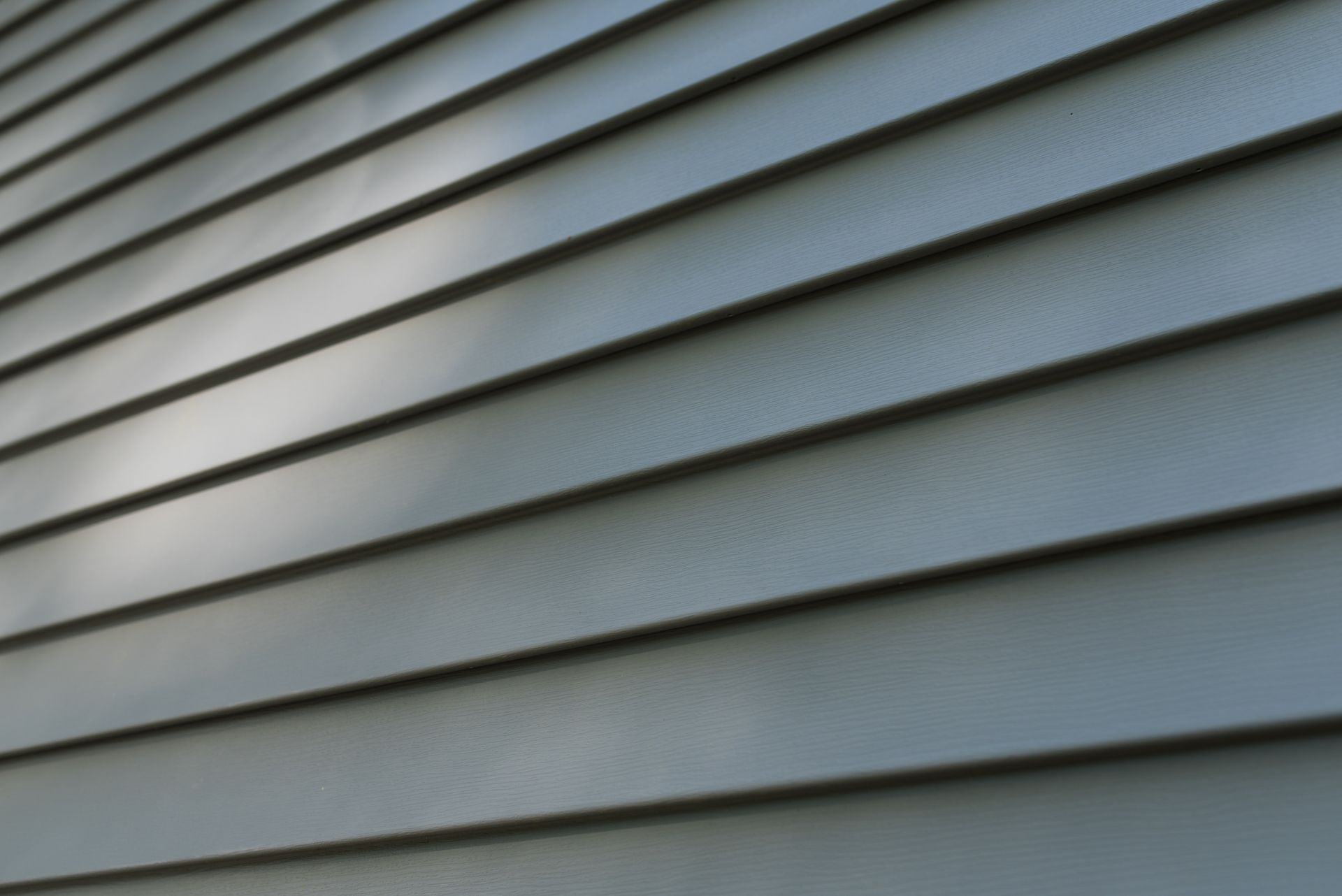 A close up of a gray siding on a house