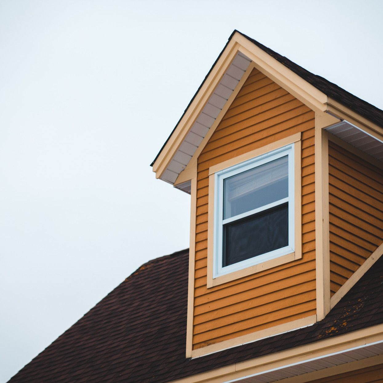 The roof of a house with a window on it