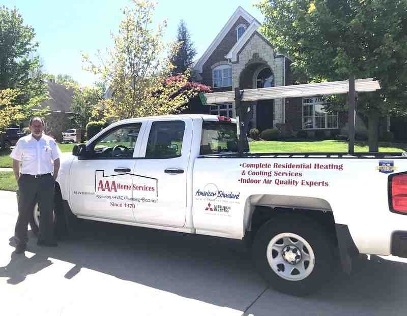friendly AAA Home Services technician with a van - furnace tune up specials