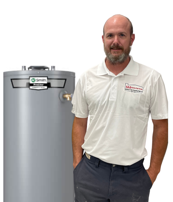 Man standing beside a gray water heater, wearing a white polo shirt and dark pants.