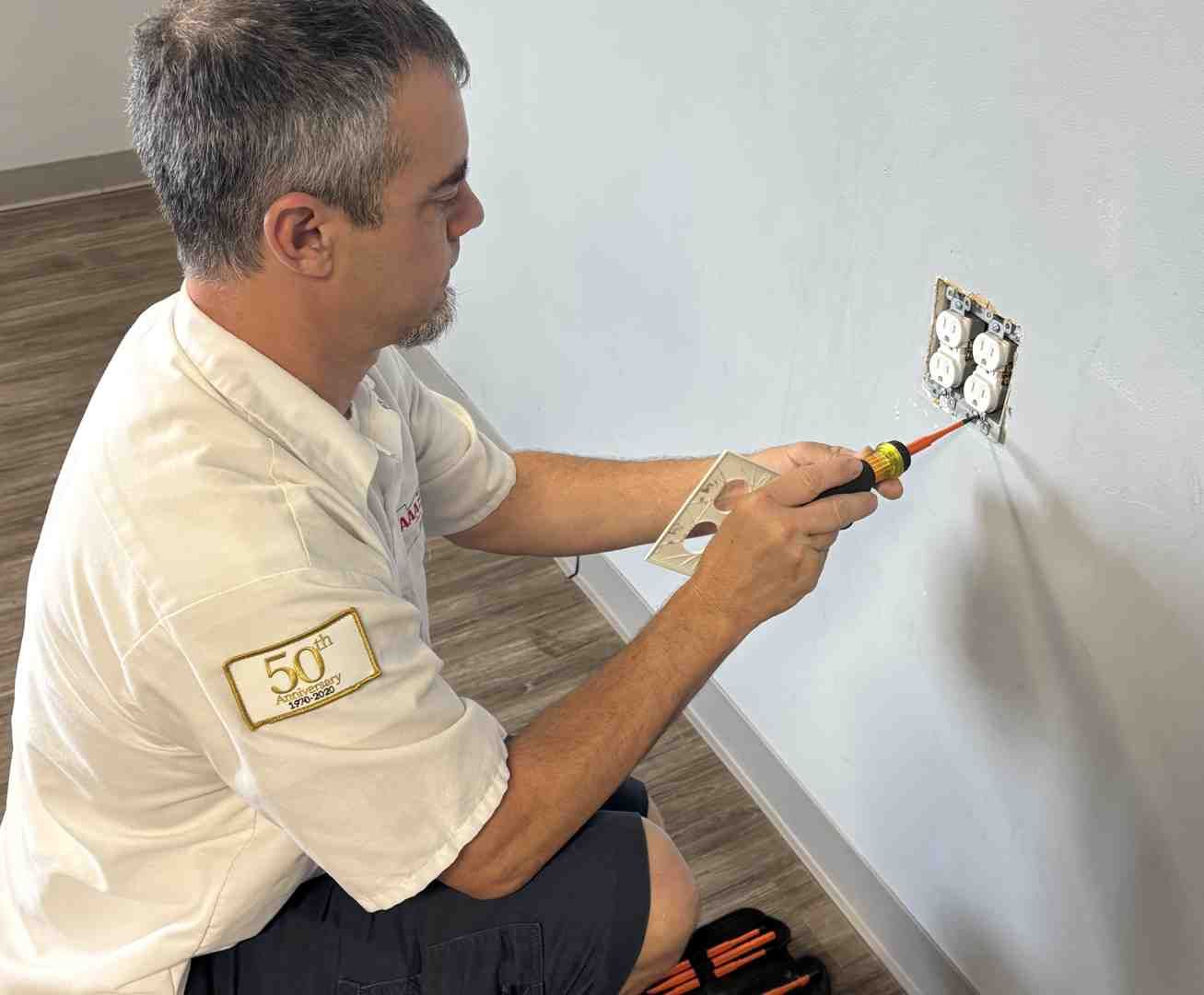 close-up of faulty electrical outlet with burn marks - electricians residential near me