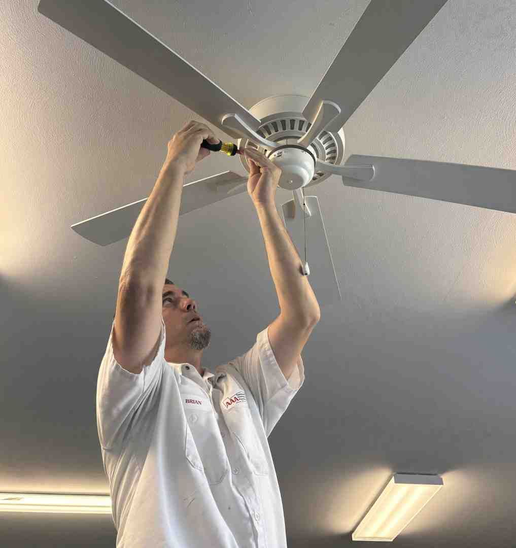 electrician installing ceiling fan - electricians residential near me