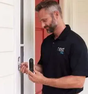 Man in black polo unlocking a front door with a smart lock