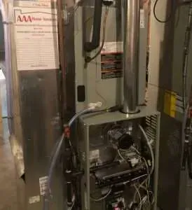 Industrial furnace equipment with exposed piping and wiring in a utility room