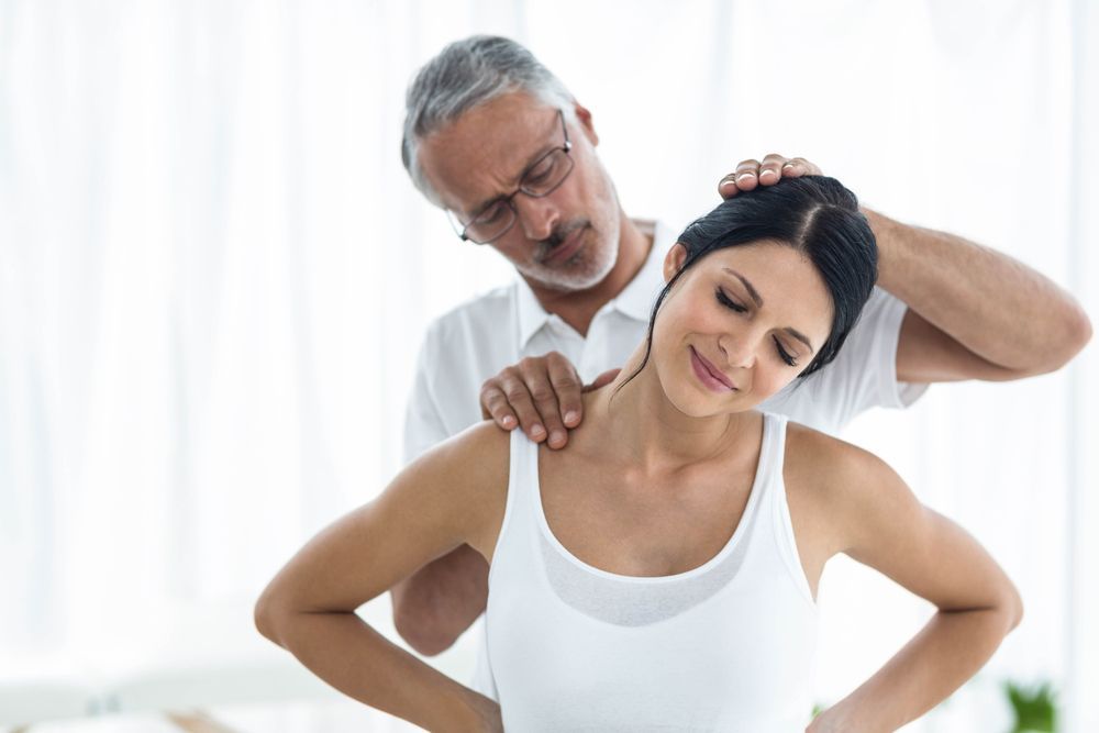 Woman Receiving Neck Massage from A Man with Gray Hair — R & R Relaxation and Remedial In Northern Rivers, NSW