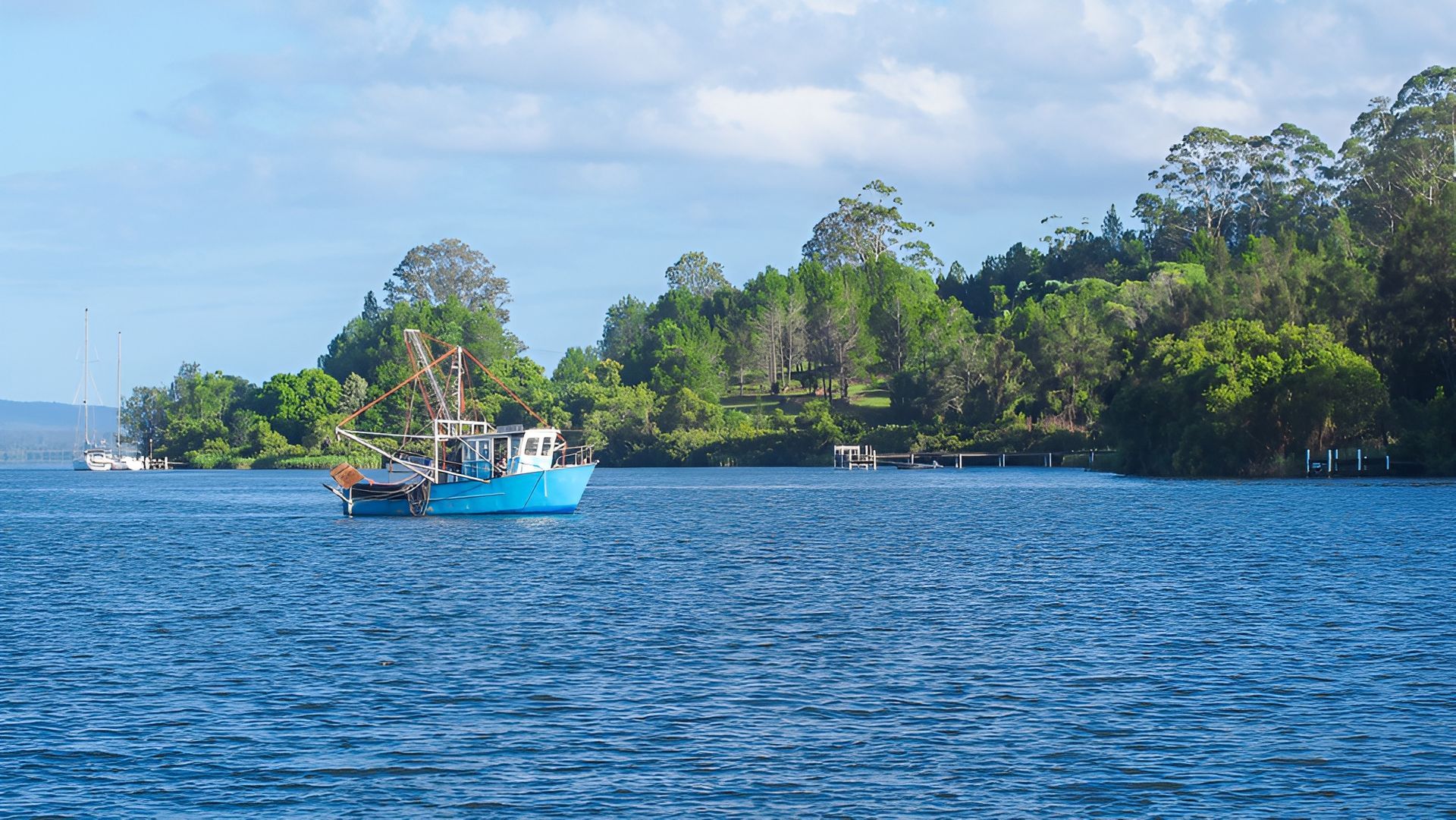 Blue Fishing Boat on A Blue Waterway — R & R Relaxation and Remedial In Maclean, NSW