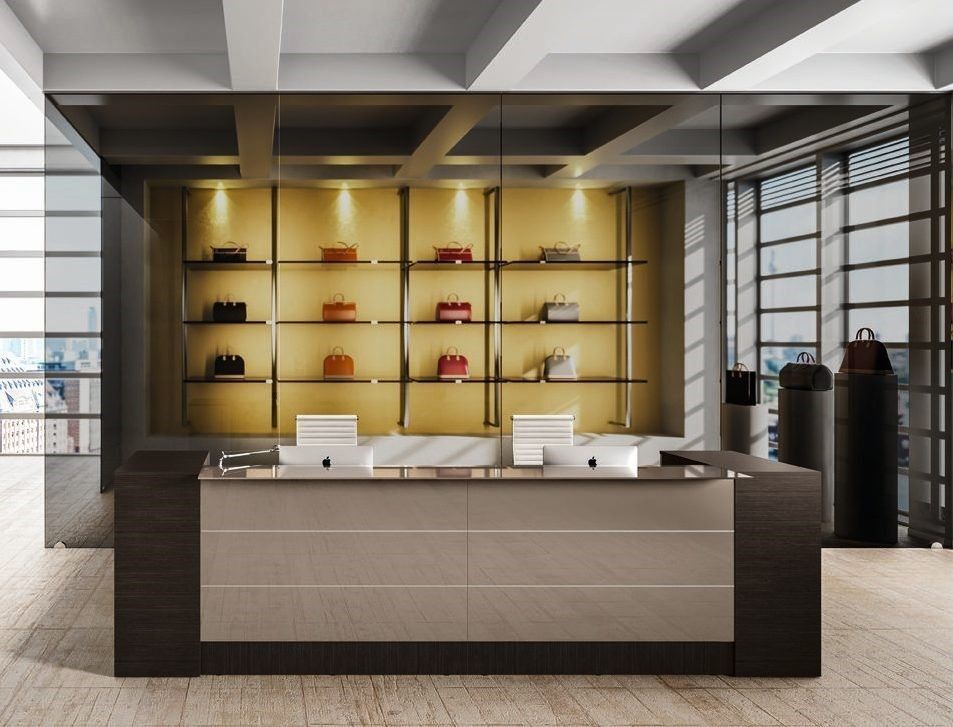 Una reception moderna e minimalista in un negozio di lusso, con scaffali retroilluminati che espongono borse firmate.