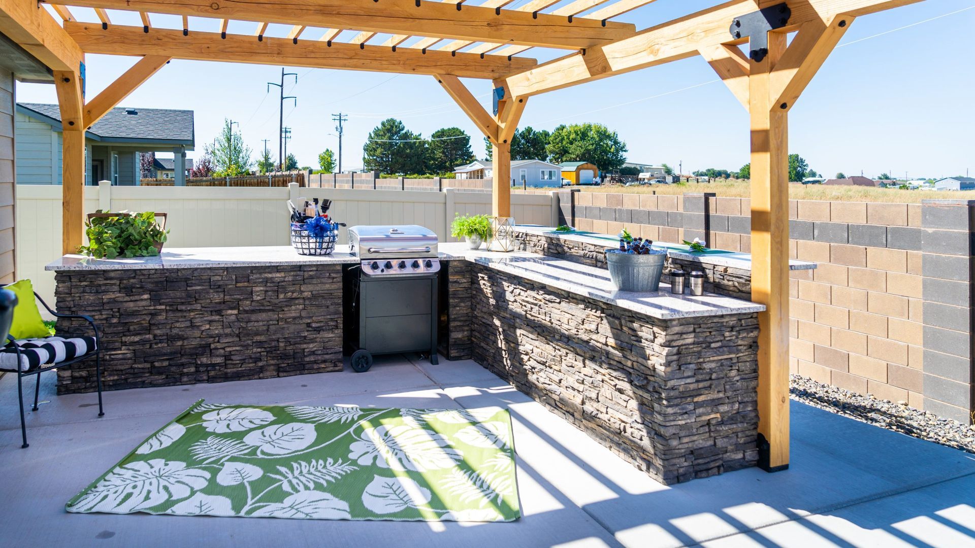Backyard outdoor kitchen area with pavers in a San Diego landscape