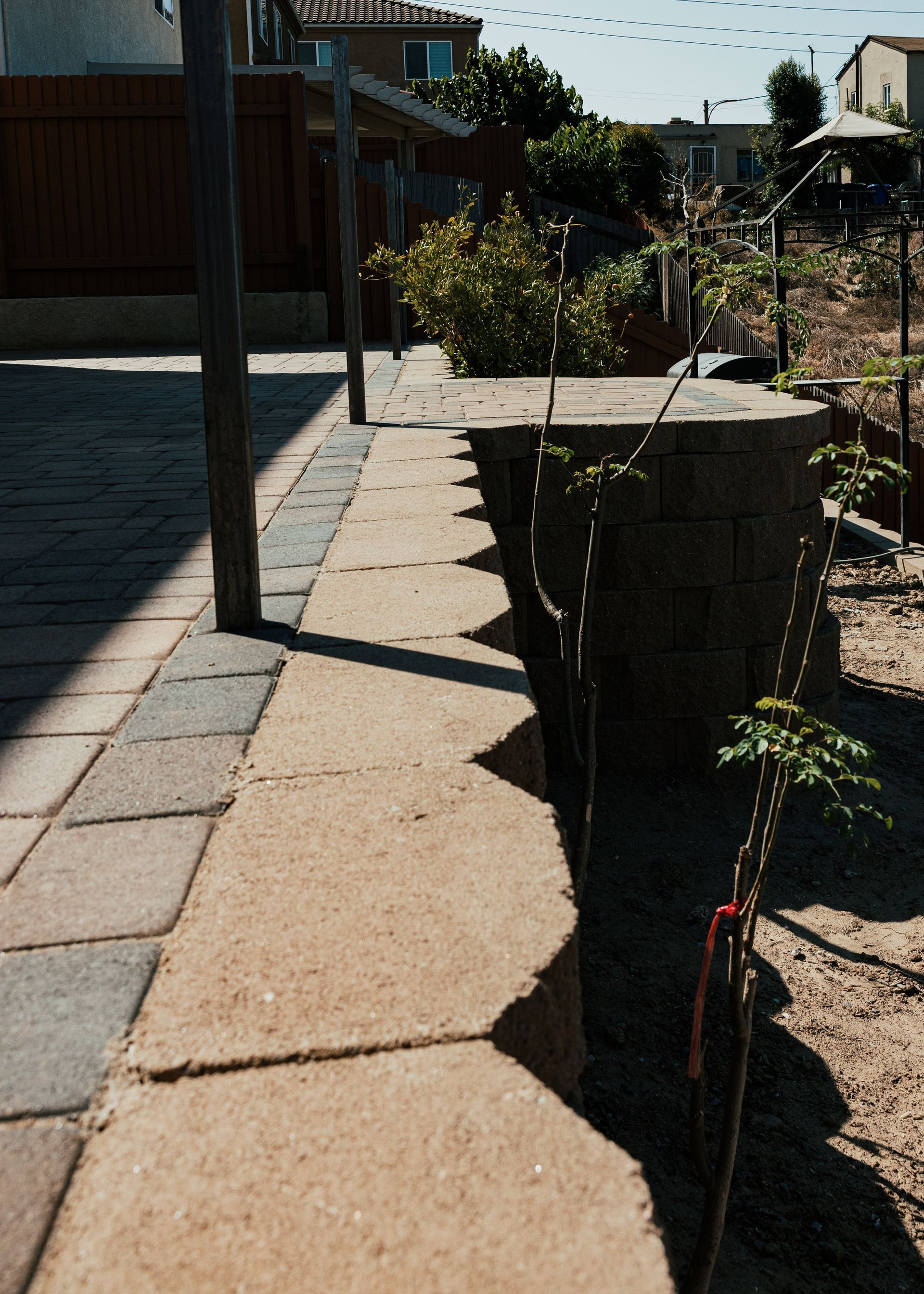 Backyard landscape in San Diego with pavers retaining wall and outdoor design features