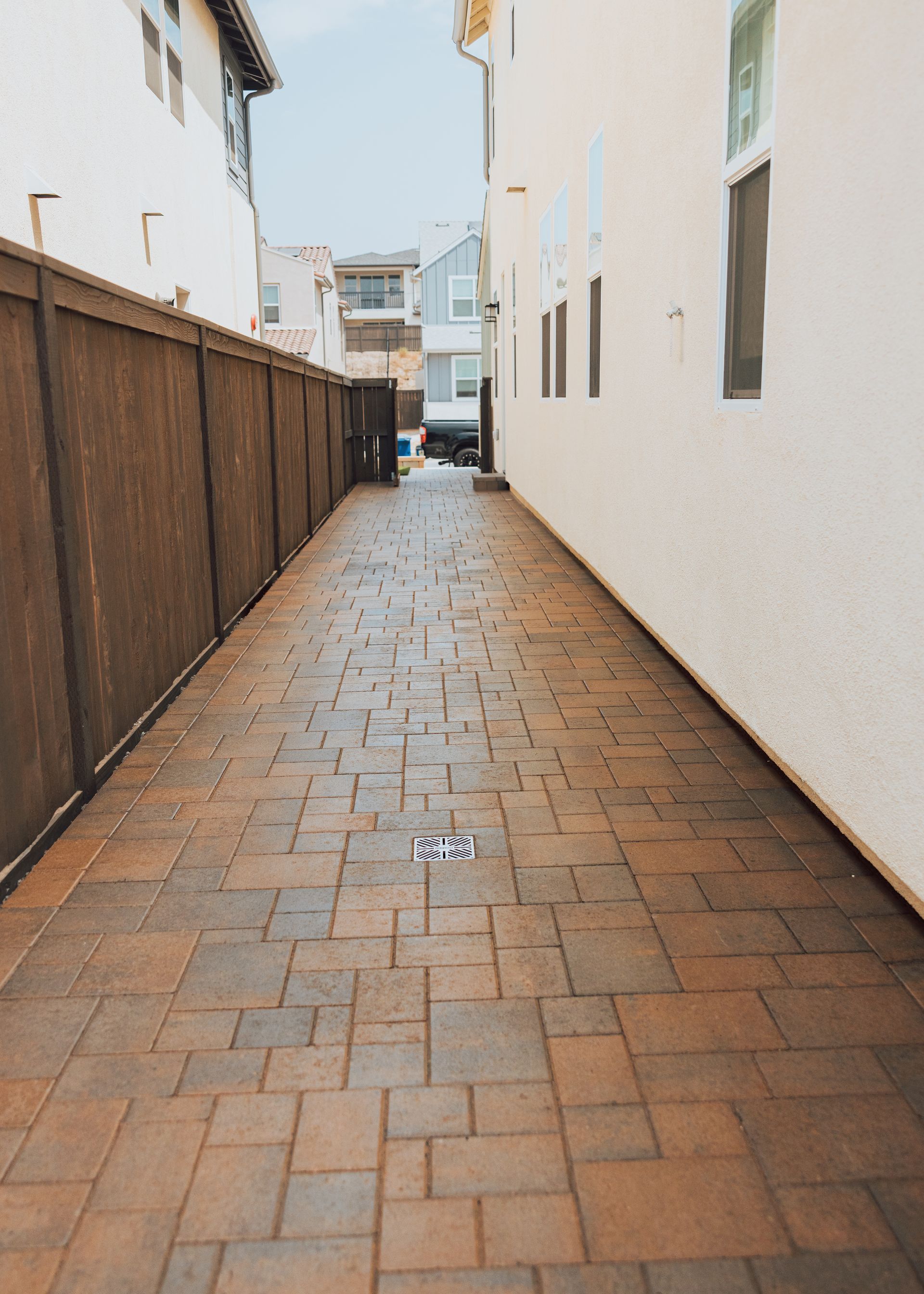 paver walkway along side yard corridor leading to backyard landscape design in san diego home