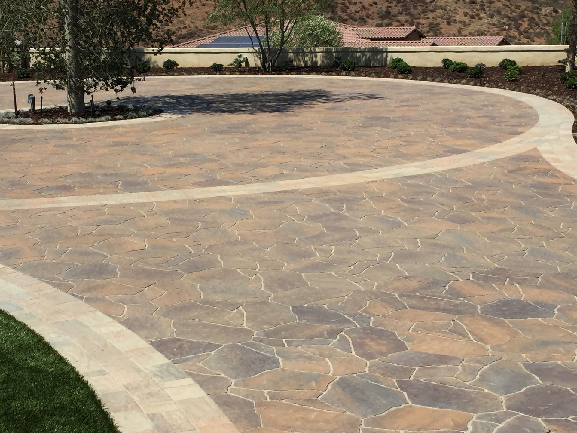 Custom back patio with concrete and pavers in San Diego residential yard